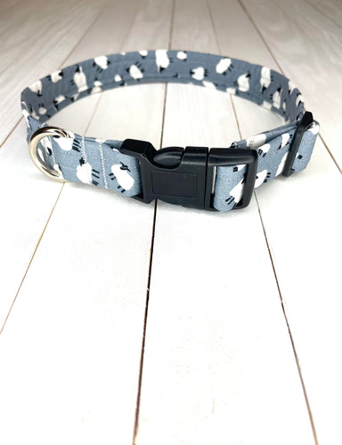 Dave the Sheep Collar. Light Grey dog collar with white and black sheep print over it. Black hardware with silver D ring. Lunapalooza logo on left hand side. Available in size puppy, small, medium, large and extra large. 